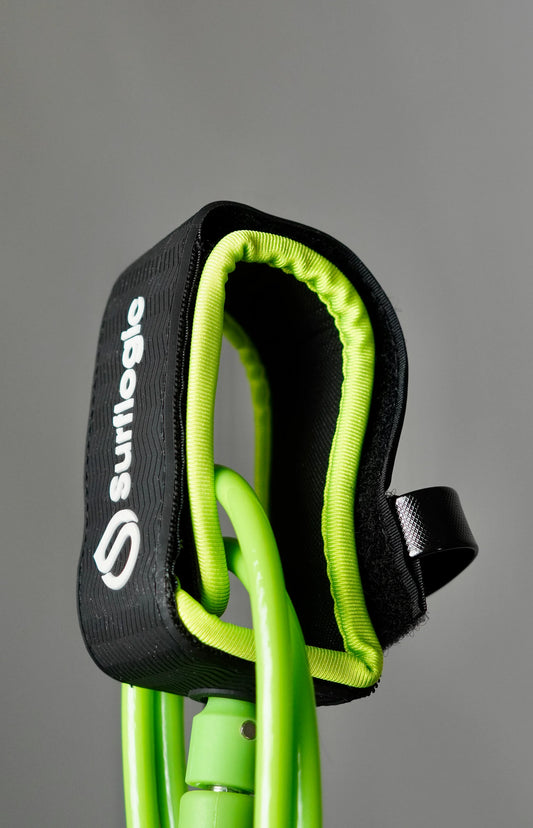 Close-up of the neon-green Surflogic leash with padded ankle cuff and quick-release pull tab