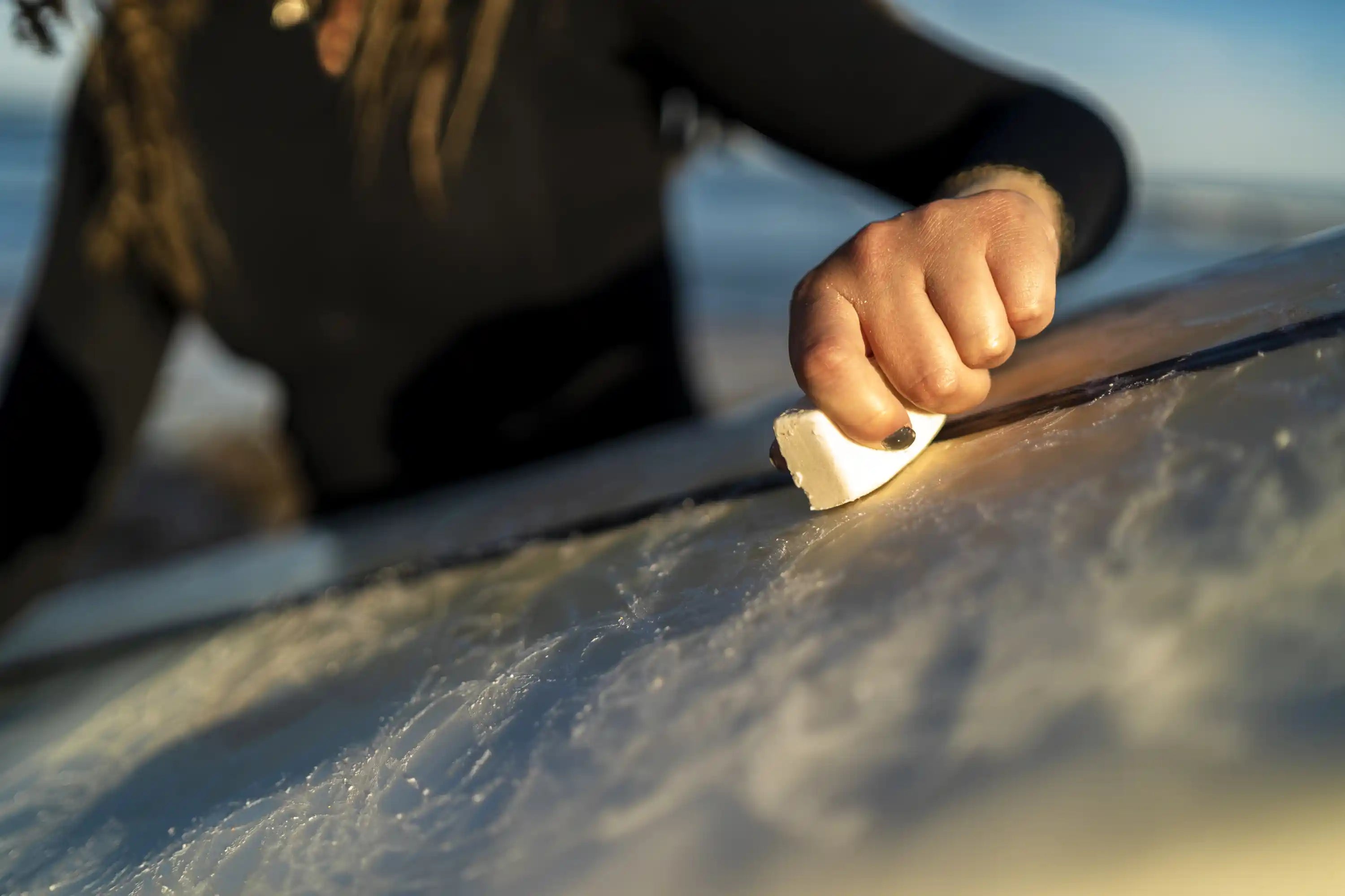 surf wax hand on board