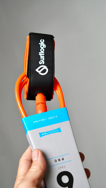 Close-up of the orange Surflogic leash with ankle cuff and cord connector