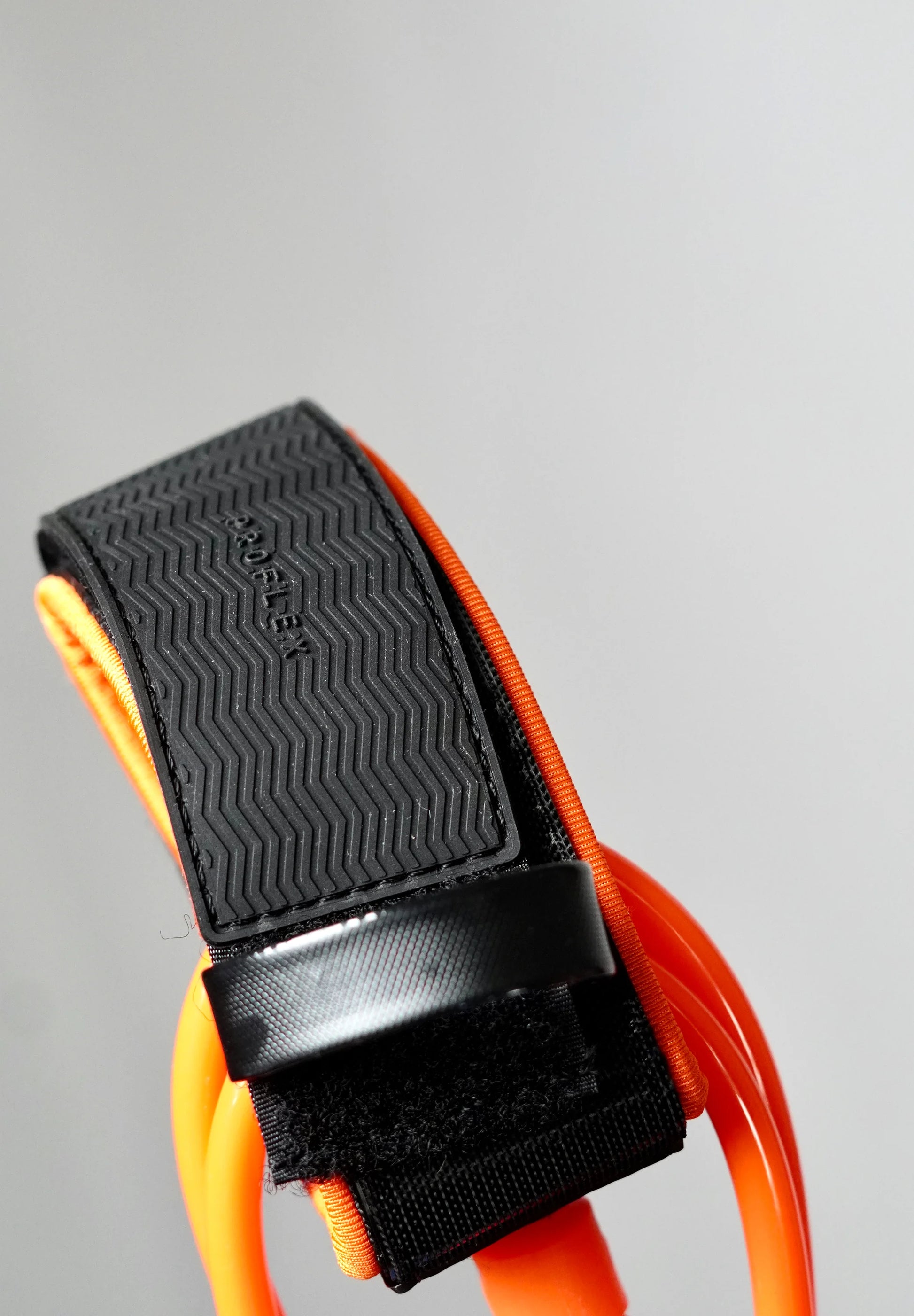Close-up of the orange Surflogic leash with non-slip ankle cuff and closed Velcro