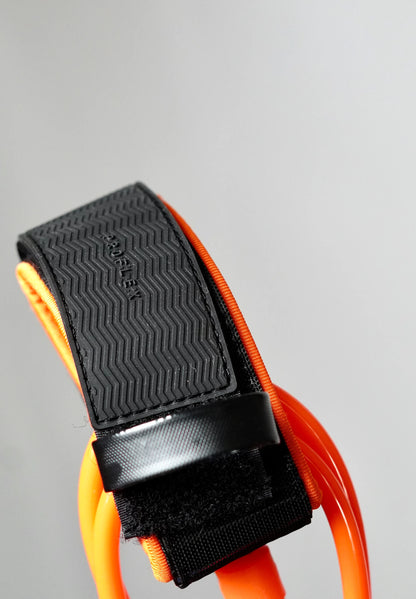Close-up of the orange Surflogic leash with non-slip ankle cuff and closed Velcro