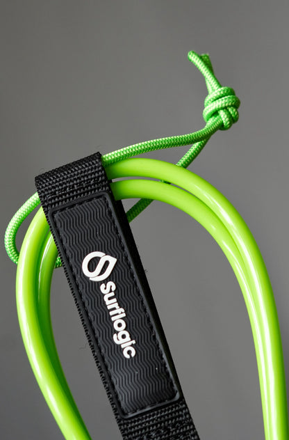 Close-up of the neon-green Surflogic leash with leash string and coiled cord