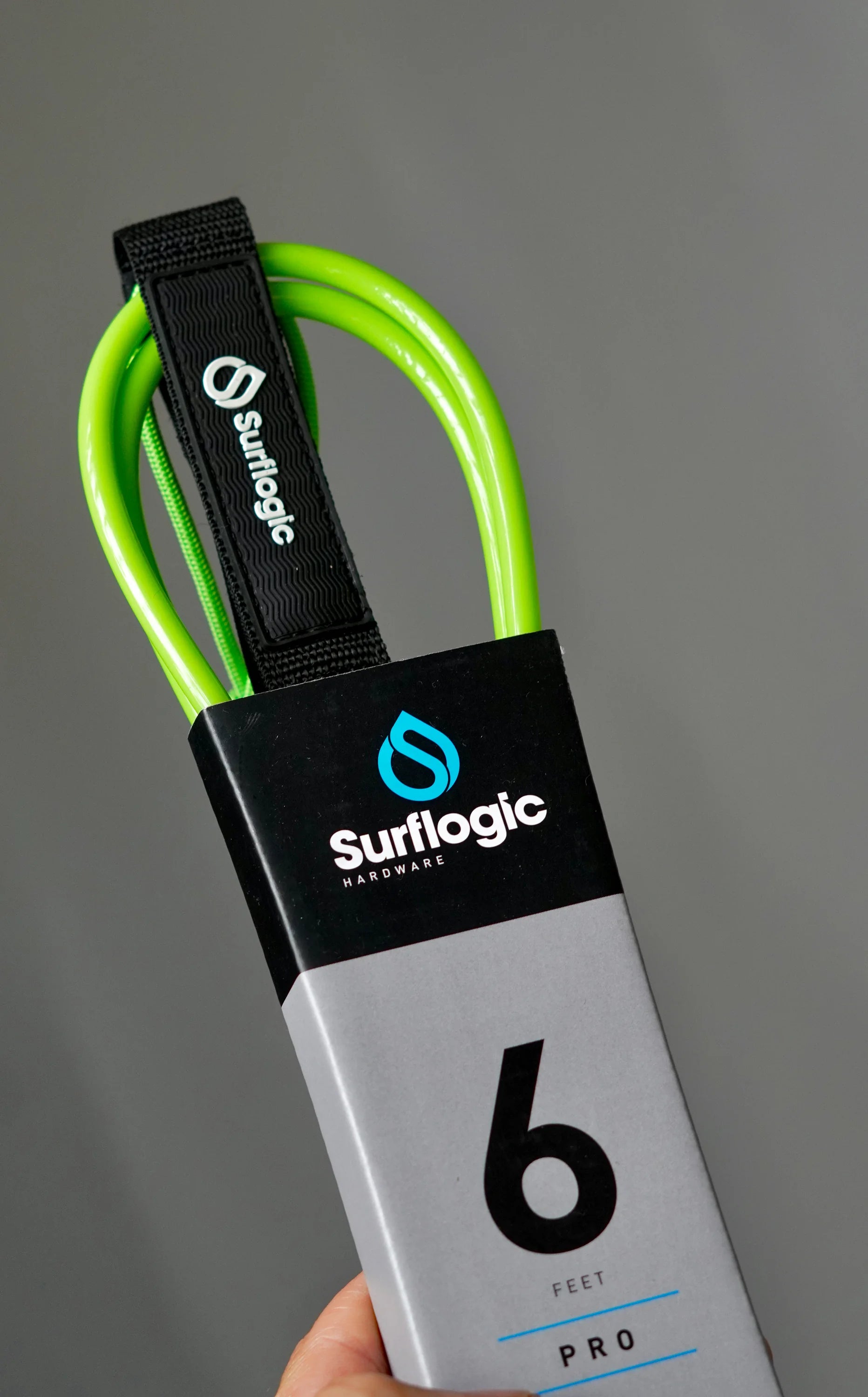 Neon-green Surflogic Leash Pro 6' in packaging, held in hand