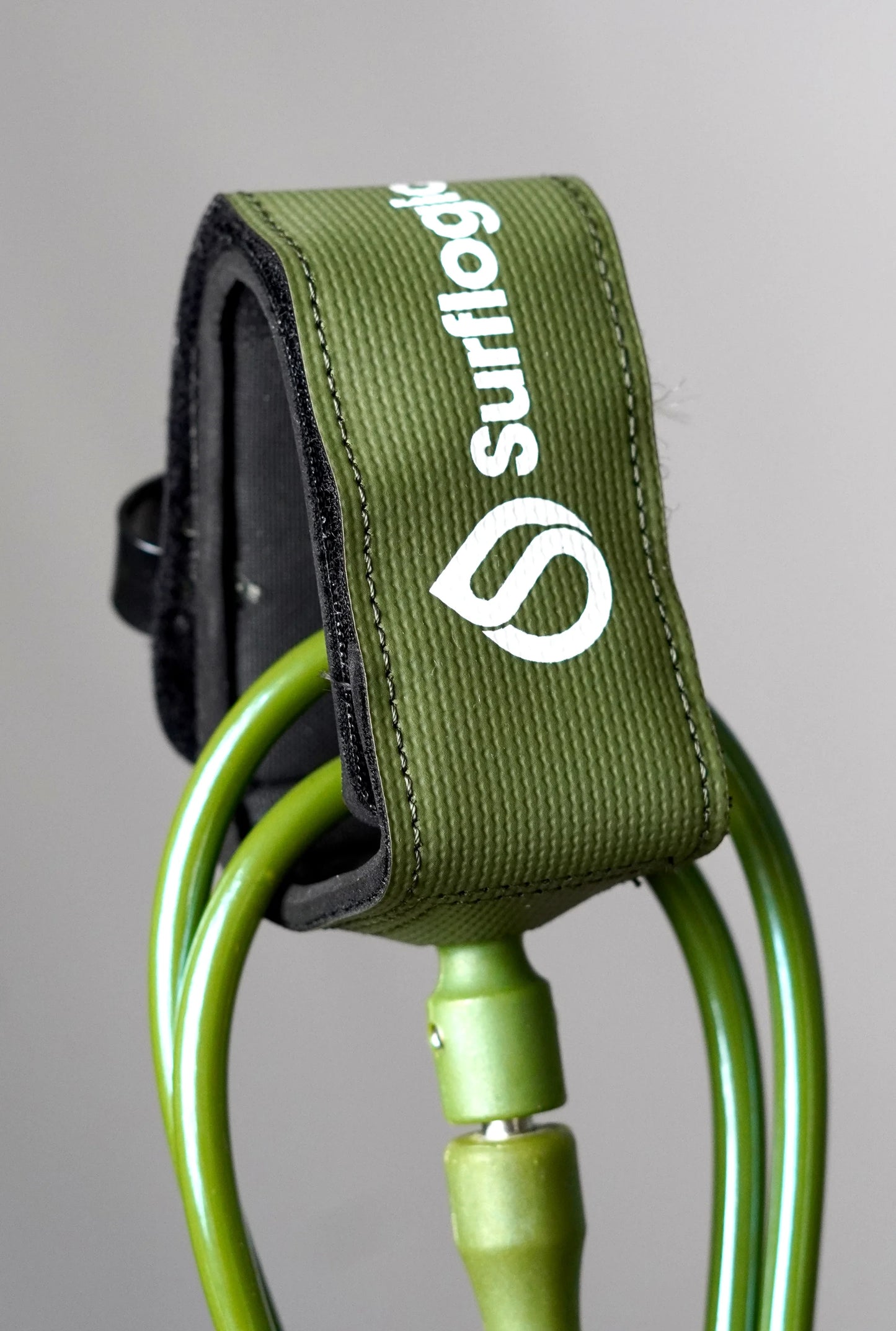 Close-up of the olive Surflogic leash with ankle cuff and cord connector