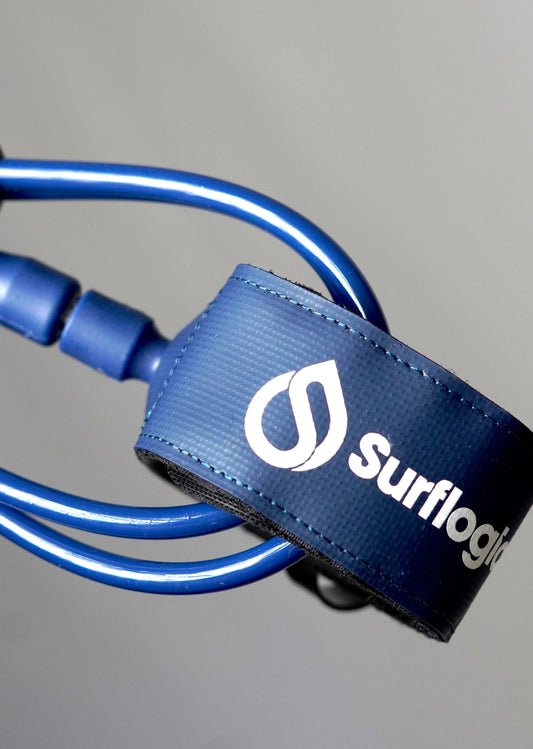 Close-up of the navy Surflogic leash with blue cord and connector