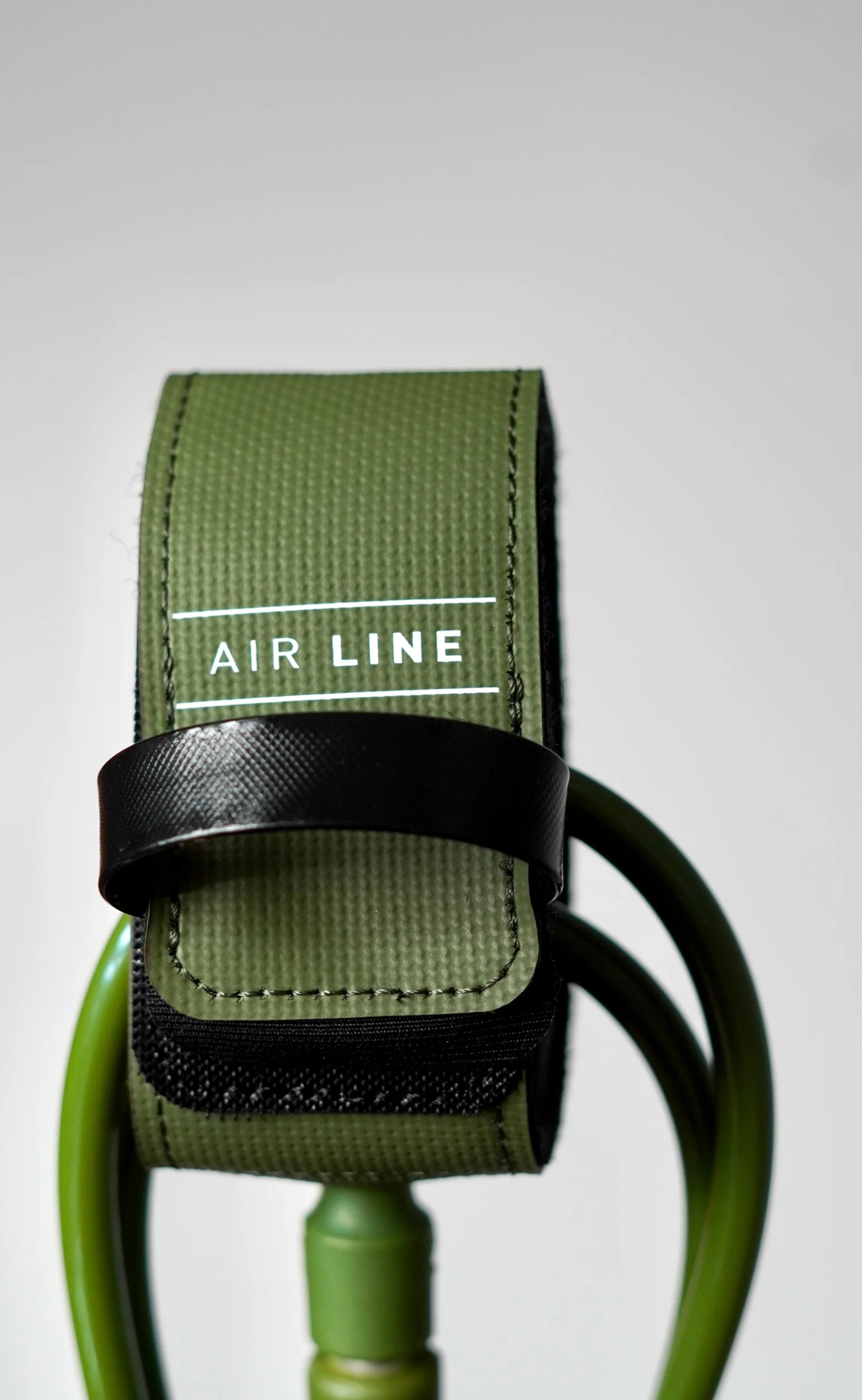 Close-up of the olive Surflogic Air Line leash with closed Velcro