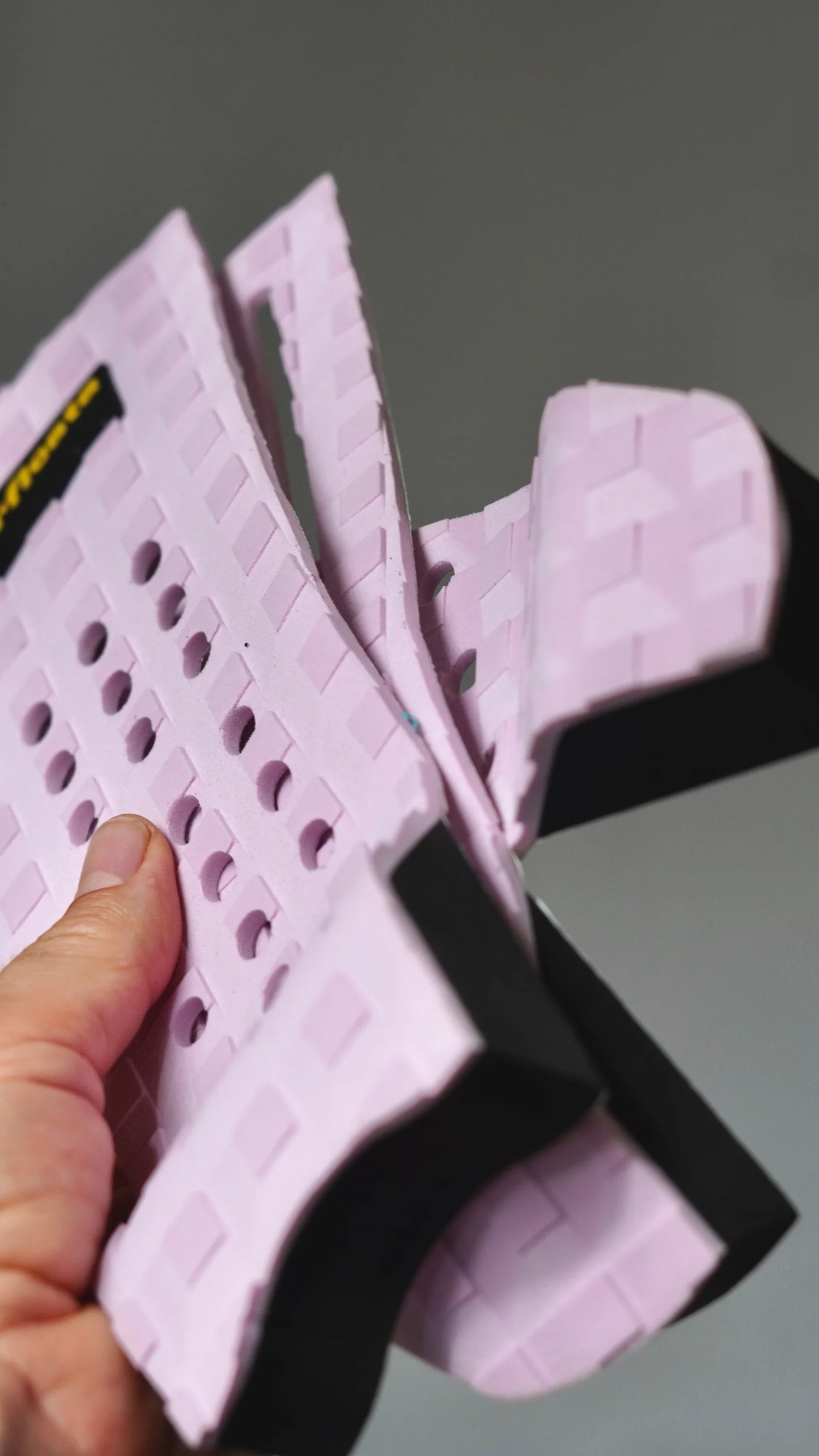 Ohebný růžový tail pad Surficata Pink Flamingo s viditelnou černou spodní vrstvou.